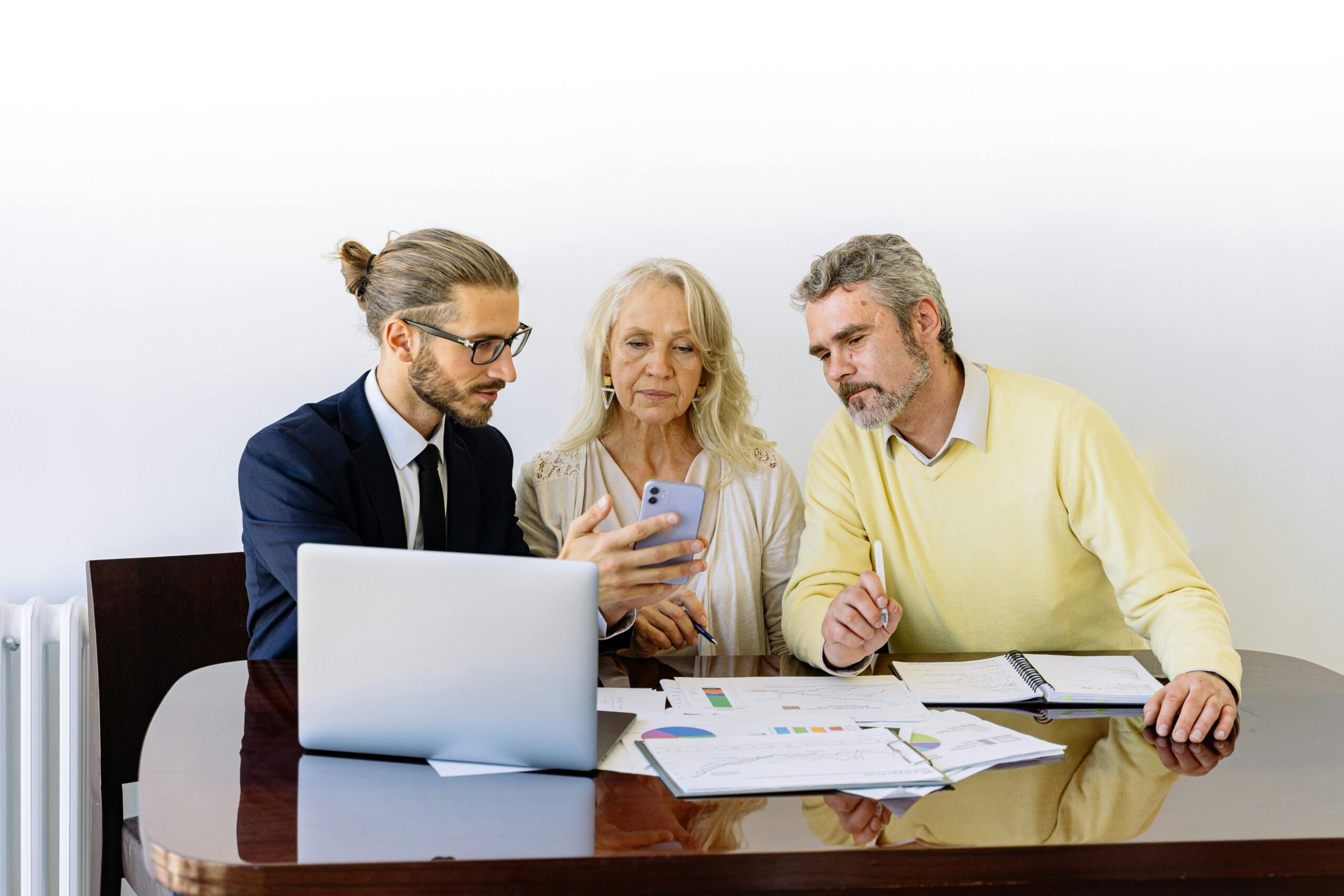 Agent discussing policy with senior male and female client-Car Insurance in Michigan-Comprehensive Car Insurance in Michigan